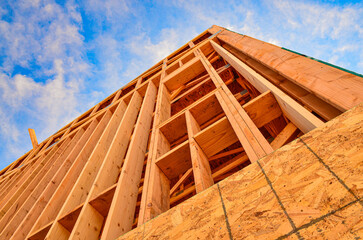Low angle view of construction techniques for wood frame commercial building.