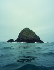 A small rock in the middle of the ocean