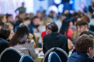 Large group interacting at a busy professional gathering, fostering collaboration and discussions.