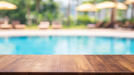 Empty wooden table with a blurred swimming pool background at a tropical beach resort, creating a relaxing outdoor summer vacation and spa atmosphere. Perfect for product display and presentation.