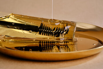 Bottle with brush filled with oil for eyebrow and eyelash growth. Texture.