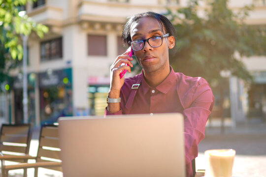 Confident LGBTQIA+ Professional: Phone Call in Cafe Setting