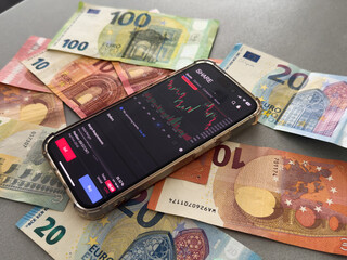 Crypto trader investor broker using cell phone app executing financial stock trade market trading...