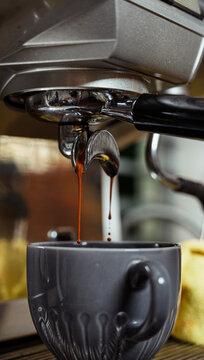 Steaming Espresso Pouring Into Elegant Cup in Cafe Setting