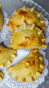 Traditional Baked Empanadas on Doily-Lined Tray