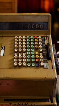 Vintage Cash Register in Cozy Cafe Setting with Warm Light