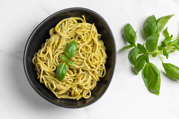 Italian pasta with pesto sauce and basil