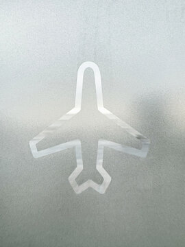 Airplane Symbol on Glass at Airport
