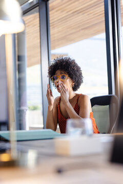 woman in office surprised by unexpected news during work meeting, copy space