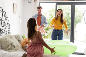 Family enjoying summer day at home, preparing for pool with inflatable ring