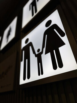 Illuminated family sign at airport terminal wall