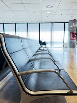 Airport terminal seating with empty chairs and travel ambiance