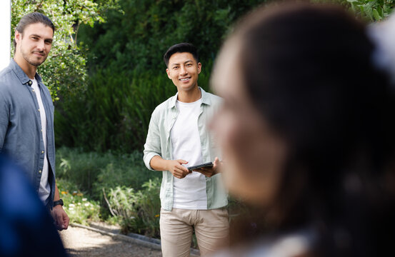 Guests smiling and enjoying outdoor small casual wedding celebration on sunny day