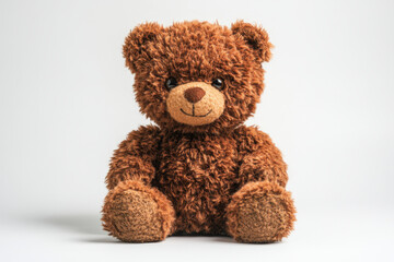 Teddy bear sitting on white surface, surrounded by colorful balloons, brightening up the room with its playful presence.