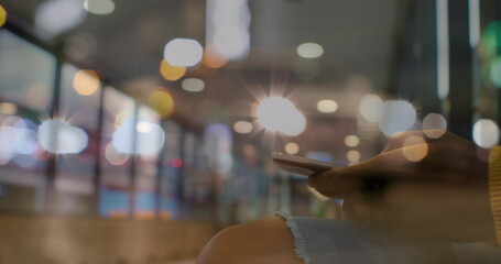 Image of people walking on street over man using smartphone