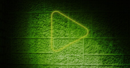Neon green play button glowing on textured brick wall background