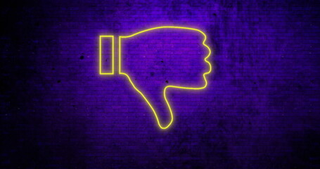 Neon yellow thumbs down sign glowing against dark purple brick wall