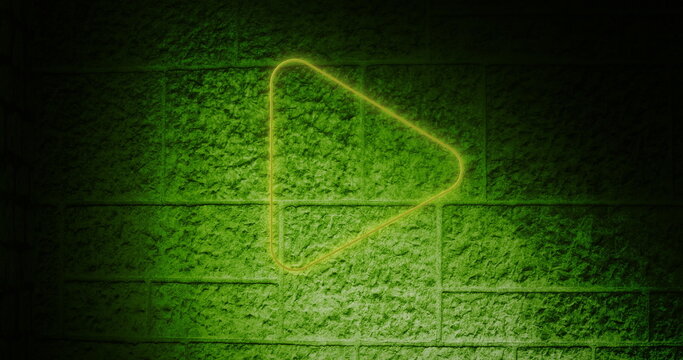 Neon green play button glowing on textured brick wall background - Powered by Adobe