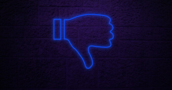 Neon blue thumbs down sign glowing against dark brick wall background
