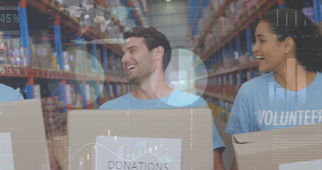Statistical data processing against male and female volunteers holding boxes smiling at warehouse