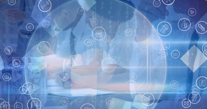 Network of digital icons and spot of light against businesspeople taking notes at office - Powered by Adobe