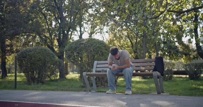 A man sits on a park bench, expressing a range of emotions, from contemplation to frustration and relief.