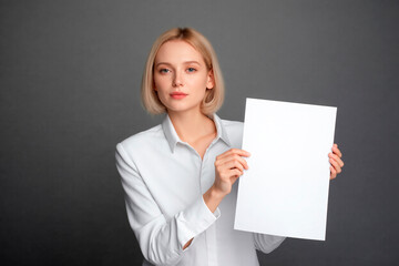 Naklejka premium creative businesswoman holding white A4 sheet of paper,