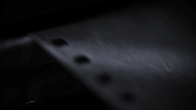 Close-up hand pulling the Photographic Plate 35 Mm film out of an old school retro photography camera
