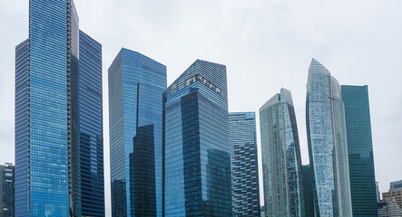 Fototapeta premium View of modern business skyscrapers glass and sky view landscape of commercial building in central city Singapore