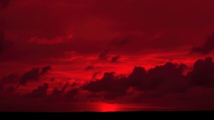 Obraz premium Abstract dark red background. Dramatic red sky. Red sunset with clouds. Fantastic sunset background with copy space for design. Halloween, armageddon, apocalypse, end of the world concept.