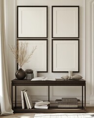 Four blank frames on a wall above a console table with decor.