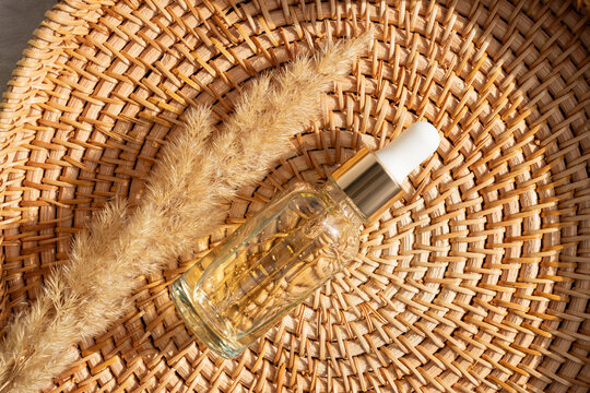 Serene arrangement, essential oil on woven basket and dried grass