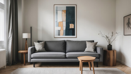 Serene living room featuring a calming gray sofa, adorned with soft cushions, centered beneath an abstract artwork, bathed in soft, natural light.