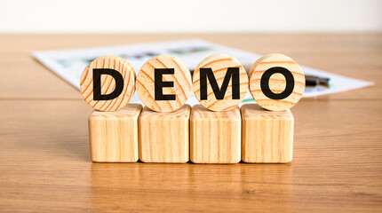 Demo symbol. Concept word Demo on beautiful wooden circles on wooden blocks. Beautiful wooden table white background. Business and demo concept. Copy space.