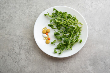 Fototapeta premium Peas sprouted and tablets on a plate. Healthy food