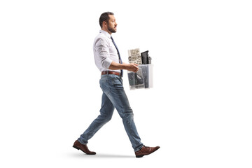 Full length profile shot of a man walking and carrying a box of electronic waste