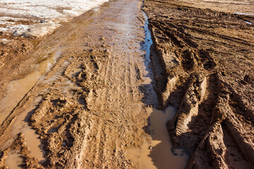 Spring thaw with a muddy mess on the road