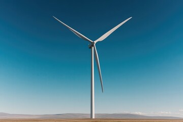 Obraz premium solitary wind turbine stands tall against clear blue sky on vast plain its blades gently rotating showcasing renewable