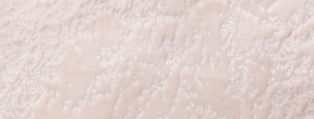 Texture light beige velvet background from soft upholstery textile material, macro. Abstract pearl pastel velour fabric