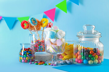 Candy bar. Many different sweets on light blue background