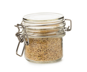 Raw brown rice in jar isolated on white
