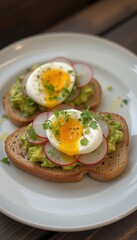 Delicious avocado toast topped with soft-boiled eggs and radishes  