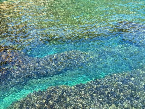 Mediterranean sea clear emerald blue surface with underwater algae.