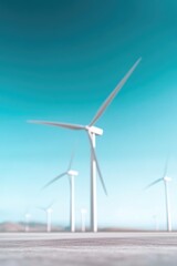Fototapeta premium field of wind turbines under clear blue sky blades spinning gracefully in harmony with nature illustrating pure essence