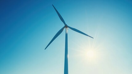 Fototapeta premium Serene wind turbine against a clear blue sky generating clean energy on a sunny day renewable power source sustainable future environmental friendly
