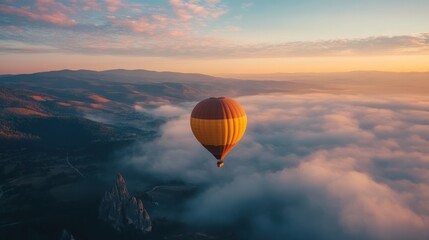 Obraz premium A colorful hot air balloon floats above the morning clouds