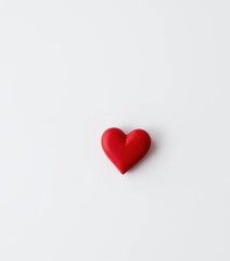 Fototapeta premium Simple white background with a single red heart, shape, feeling