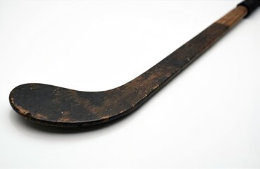 Old hockey stick rests on white background. Vintage wooden sports equipment for ice hockey game. Antique retro design, wooden texture. Ideal for design, sports, history, retro, nostalgia themes.