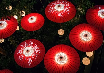 Red paper umbrellas with white designs on them Japanese pattern