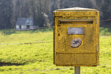 Old French yellow mailbox of the former French national postal company. On which is written 